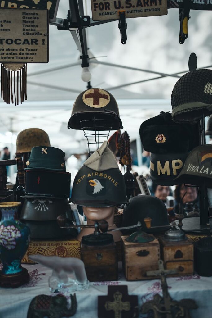 Collection of vintage military helmets showcased at an outdoor market stall with historical memorabilia.